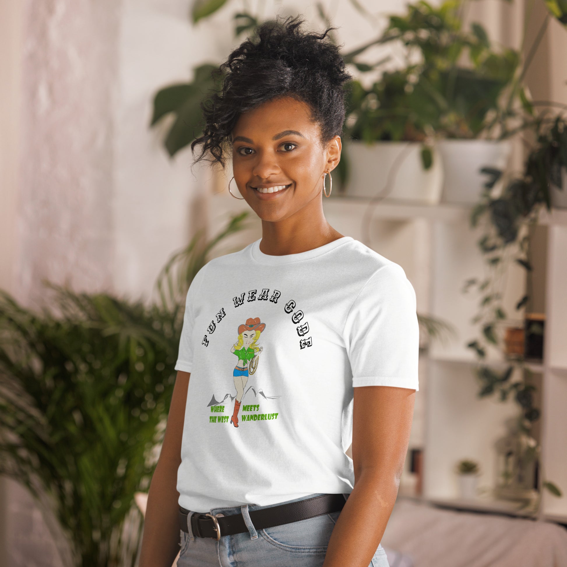 Person wearing a white t-shirt with a graphic design of a cowgirl and text " FUN WEAR CODE", standing in a casual setting with plants.