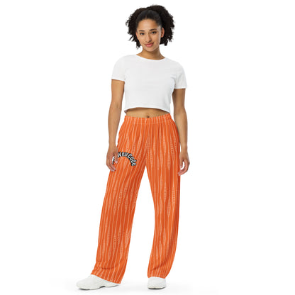 Person wearing orange patterned pants with a 'Fun Wear Code' text logo and a white crop top on a white background