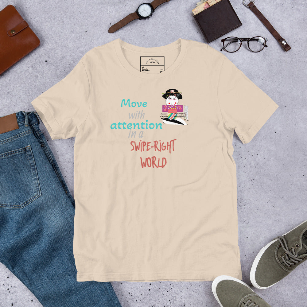 Beige t-shirt with a playful geisha graphic design and text on a gray surface with jeans, shoes, and accessories.
